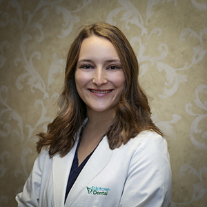 Dr. Andrea Racic Smiling in a white coat